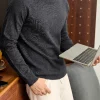 Men's merino wool turtleneck sweater in charcoal grey, featuring a high folded neck and slim fit.